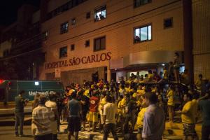 Fans gather outside São Carlos Hospital in Fortaleza for updates on Neymar. Photo Credit: AP